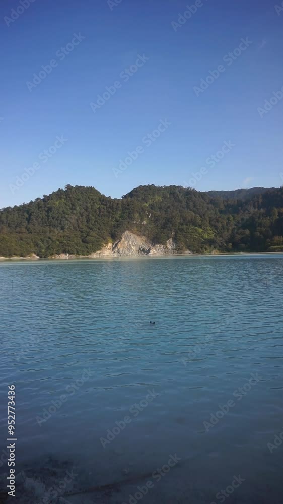 vertical video of talaga bodas crater, a tourist attraction in garut indonesia, with green trees under a bright blue sky in the afternoon vertical video of talaga bodas crater, a tourist attraction in garut indonesia, with green trees under a bright blue sky in the afternoon