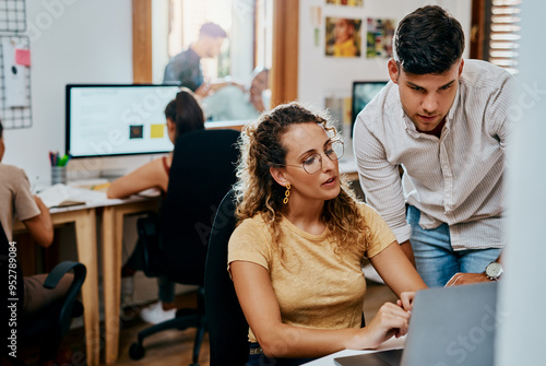 Business, employees and laptop in office for research results on creative ideas as magazine editor. Coworking, people and serious on website for teamwork, collaboration and strategy for project
