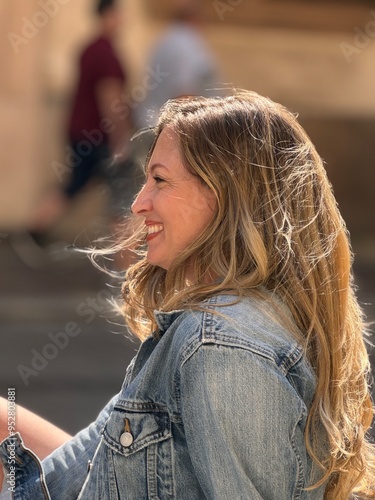 portrait of a blond haired woman sitting outside in the wind