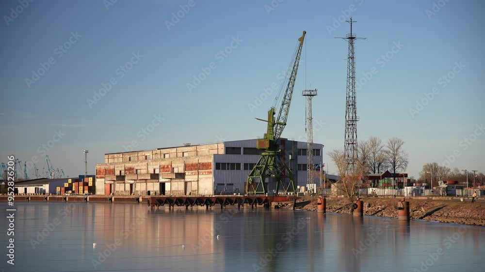 frozen river next to a dock and a crane