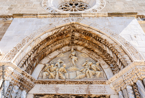 Lunette under a pointed arch on the facade of the Concattedrale di Santa Maria Assunta, in the town of Orbetello, province of Grosseto, Tuscany region, Italy photo