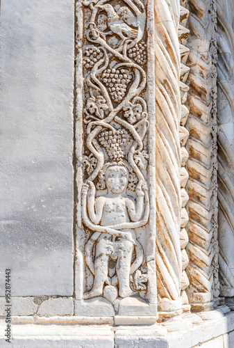 Bas relief on the cathedral gate of Concattedrale di Santa Maria Assunta, in the town of Orbetello, province of Grosseto, Tuscany region, Italy photo