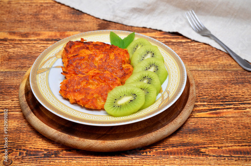 sweet potato pancakes and kiwi slices on a plate photo