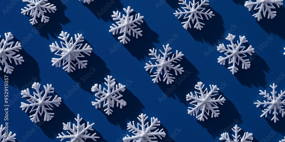 christmas tree ornaments shaped like snowflakes, each with a shadow, scattered across a deep blue background christmas tree ornaments shaped like snowflakes, each with a shadow, scattered across a deep blue background