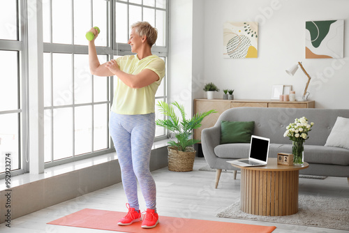 Mature woman exercising wit...