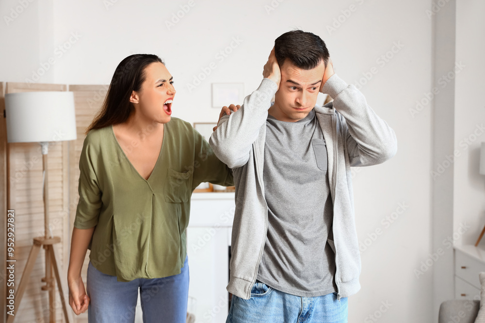Angry young woman quarreling with her husband at home Angry young woman quarreling with her husband at home