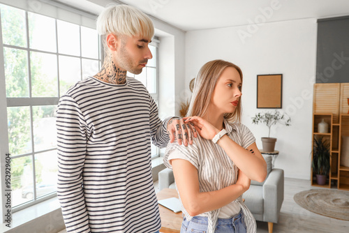 Offended young couple at home