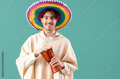 Young Mexican man with drum...