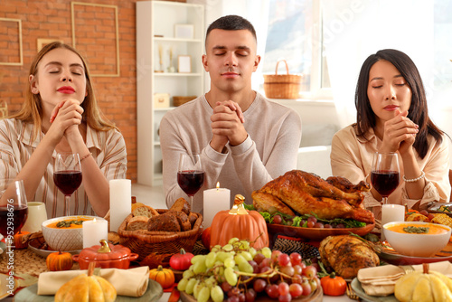 Group of young friends pray...