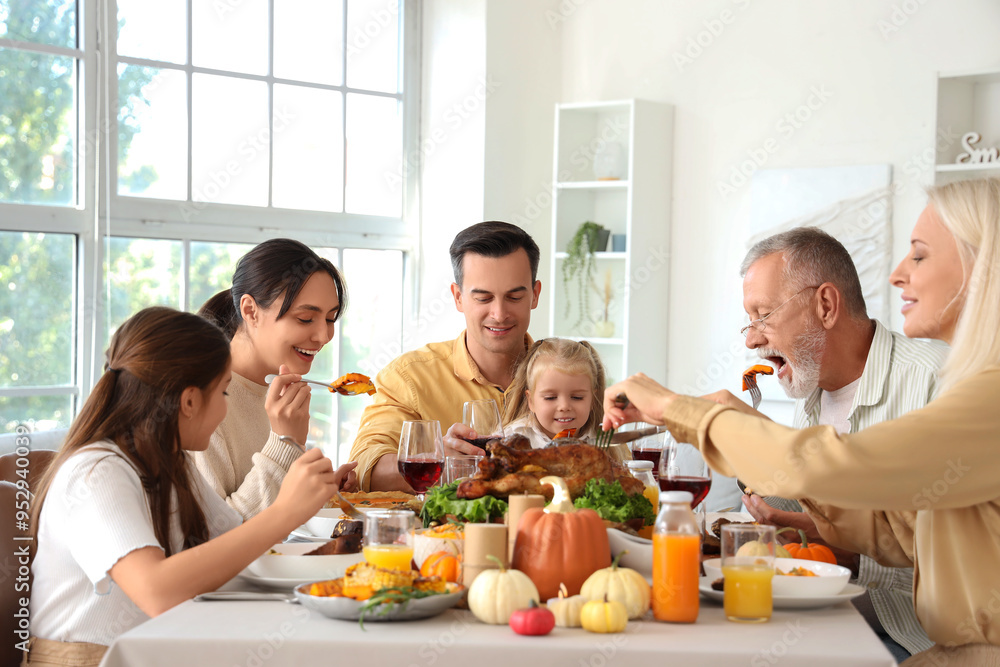 Happy family having dinner at festive table on Thanksgiving Day Happy family having dinner at festive table on Thanksgiving Day