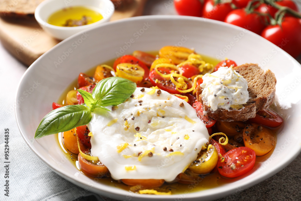 Delicious fresh burrata salad in bowl on table, closeup Delicious fresh burrata salad in bowl on table, closeup
