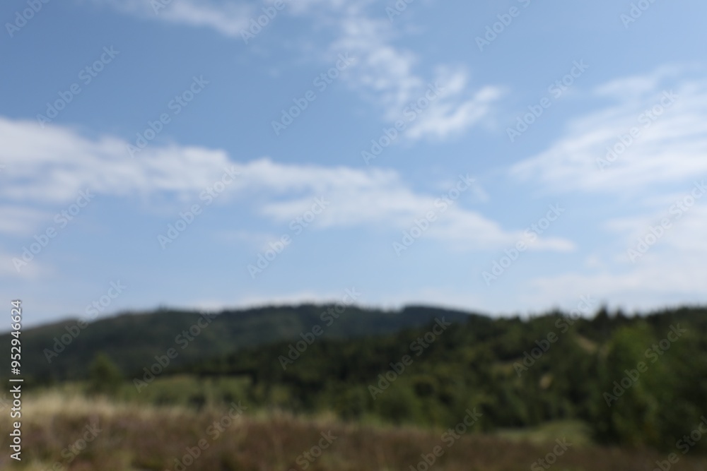 Blurred view of forest in mountains under blue sky Blurred view of forest in mountains under blue sky