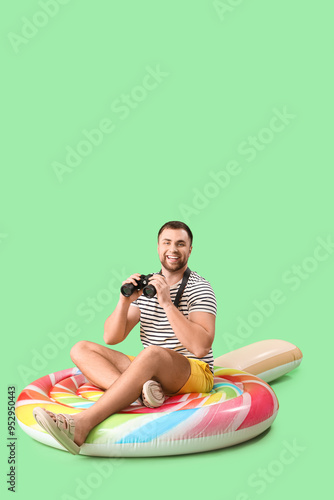 Young man with binoculars s...
