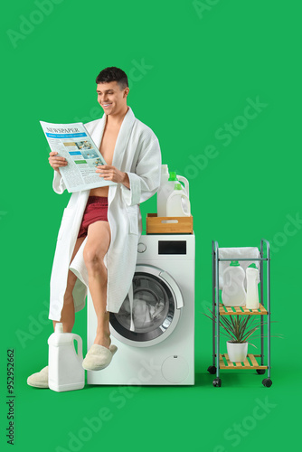 Young man in bathrobe with ...