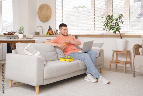 Young man with laptop and l...