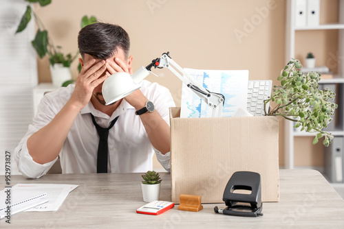 Sad fired man with box of p...