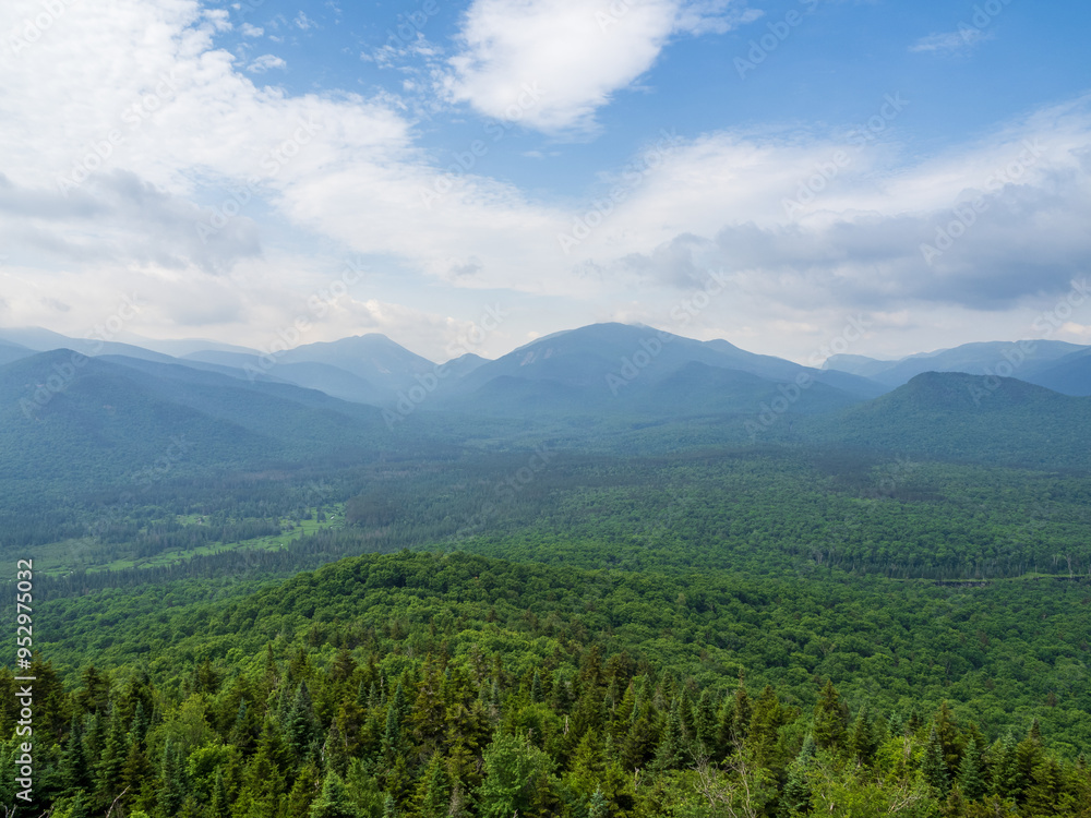 Sky clearing up over the vast Adirondack Mountains seen from the summit of Mt. Van Hoevenberg, Lake Placid, New York. Sky clearing up over the vast Adirondack Mountains seen from the summit of Mt. Van Hoevenberg, Lake Placid, New York.
