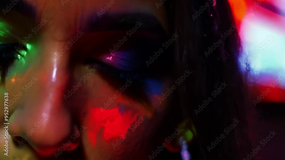 Closeup of a model showcasing fluorescent paint on her face while moving her head under ultraviolet light, creating a vibrant and artistic display in a dark nightclub setting Closeup of a model showcasing fluorescent paint on her face while moving her head under ultraviolet light, creating a vibrant and artistic display in a dark nightclub setting