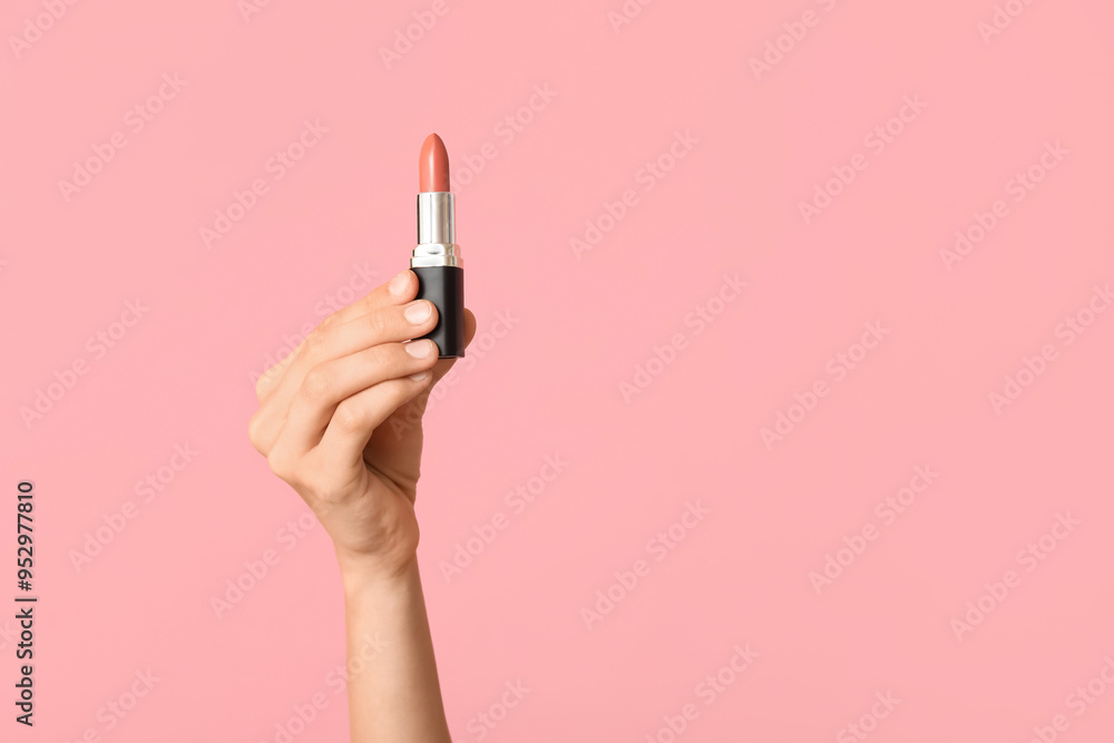 Female hand with lipstick on pink background Female hand with lipstick on pink background