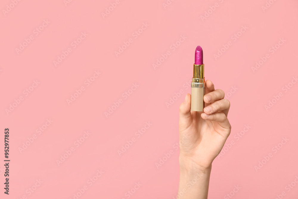 Female hand with lipstick on pink background Female hand with lipstick on pink background