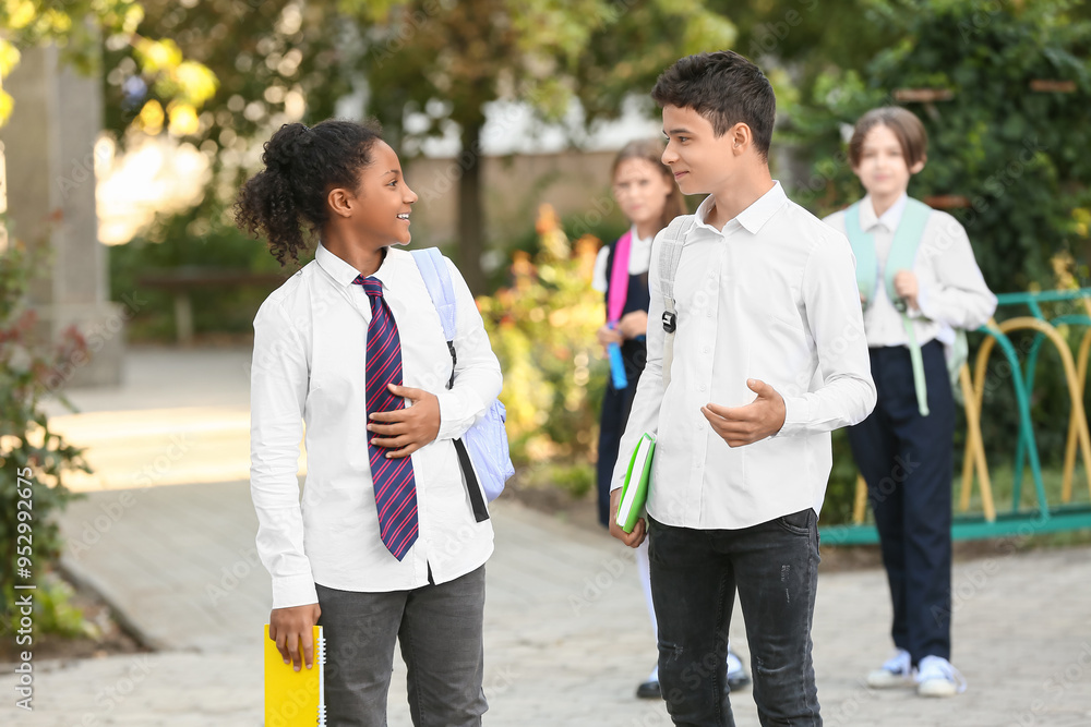 Obraz premium Group of happy pupils before school outdoors