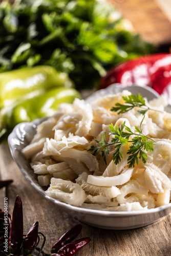 Precooked beef tripes in a bowl with vegetables and herbs ready for cooking photo