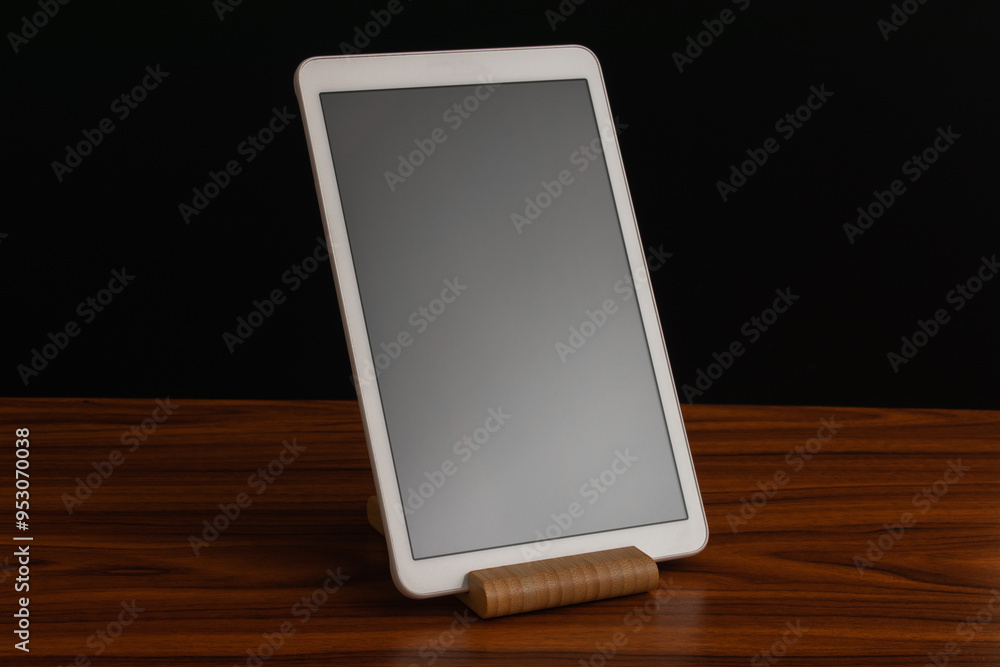 White advanced smart home control panel mounted on a wooden base and dark background. White advanced smart home control panel mounted on a wooden base and dark background.