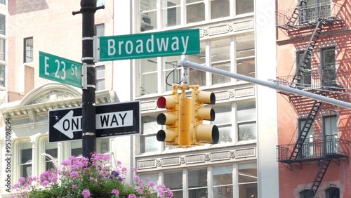 Broadway street road sign, Manhattan midtown architecture, New York City corner. Yellow traffic light. Flatiron district near Madison Square Park. Crossroad of 23 st., Bway and 5 Fifth avenue. One way