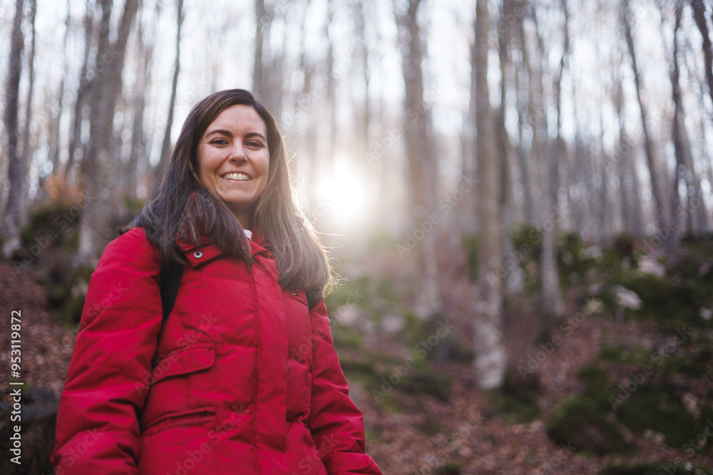 Portrait of pretty woman wearing a red jacket hiking in forest at sunset. Portrait of pretty woman wearing a red jacket hiking in forest at sunset.