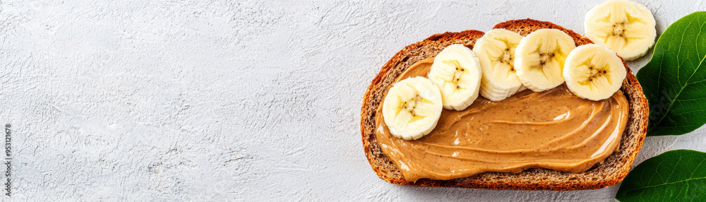 Almond butter spread on whole grain bread, topped with banana slices, brainboosting snack, healthy and satisfying Almond butter spread on whole grain bread, topped with banana slices, brainboosting snack, healthy and satisfying
