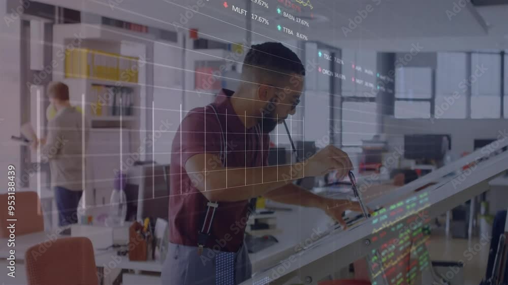 Analyzing financial data, man in office with stock market animation over workspace Analyzing financial data, man in office with stock market animation over workspace