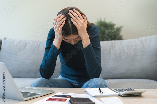 Financial owe asian woman sitting stressed by calculate expense at home, looking at invoice or bill, have no money to pay, mortgage or loan. Debt, bankruptcy or bankrupt concept