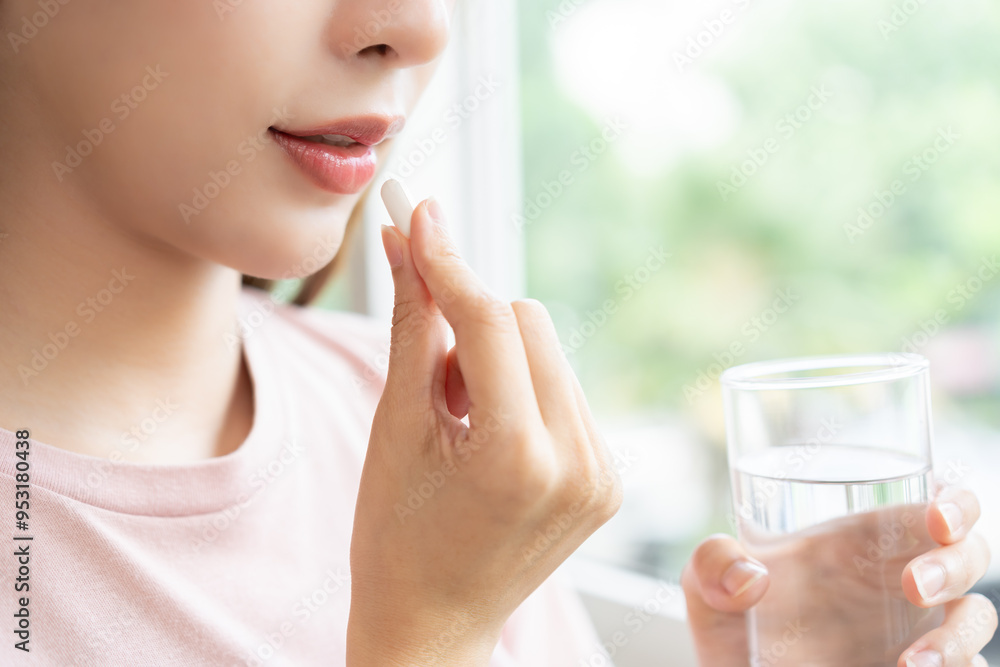 Sick, asian young woman, girl hand holding pill capsule, painkiller medicine from stomach pain, head ache, pain for treatment, take drug or vitamin and glass of water at home, pharmacy and health care Sick, asian young woman, girl hand holding pill capsule, painkiller medicine from stomach pain, head ache, pain for treatment, take drug or vitamin and glass of water at home, pharmacy and health care
