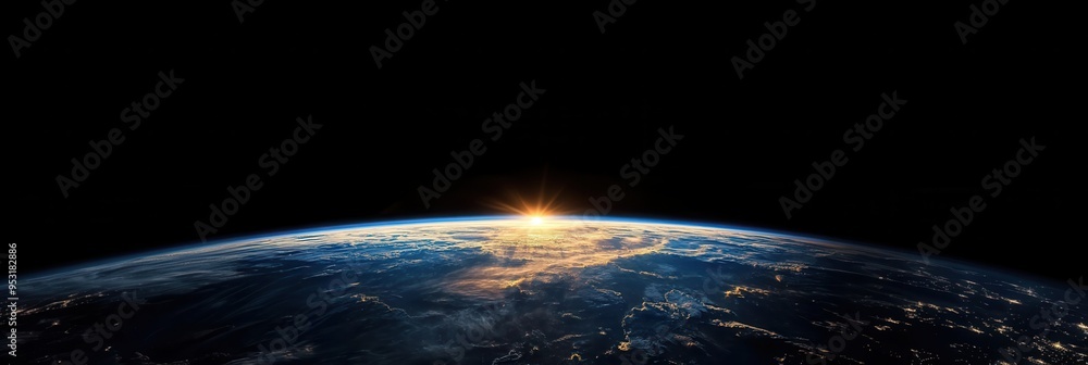 View of Earth with sunlit clouds and the atmosphere against the backdrop of black space above the planet