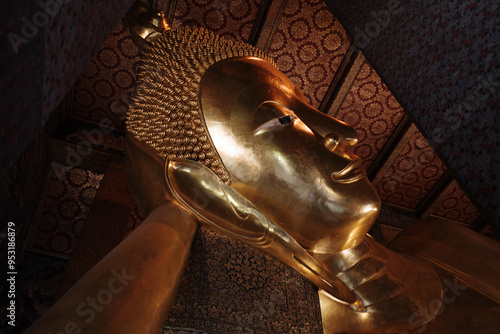 Interior view inside the temple at Wat Phra Chetuphon Wimon Mangkhalaram Rajwaramahawihan, Selective focus detail of buddha statue in sleeping pose.  photo