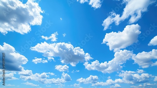 A clear blue sky with a few fluffy white clouds, offering a sense of peace and openness.