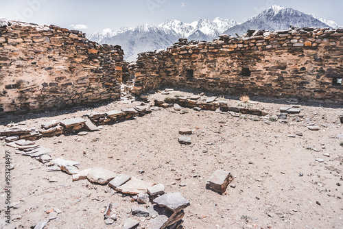 Remains of the ancient fortress of Yamchun in the Tien Shan mountains in Tajikistan in the Pamirs, ruins of a fortress fort made of stone on the background of mountains photo