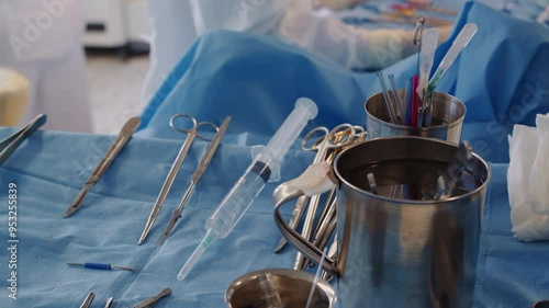 Surgeon tools set on tray closeup. Sterile instruments for coronary artery bypass surgery against working doctor in hospital. Medical equipment photo