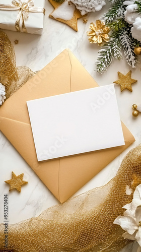 A beautiful flat lay of white postcard on golden envelope, surrounded by festive decorations, creating warm holiday atmosphere.