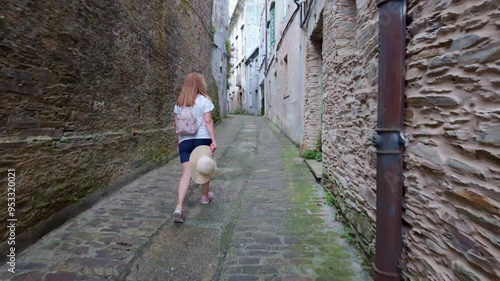 Tourist woman walking through the narrow streets of Mondonedo, passage of pilgrims who make the Camino de Santiago, Galicia.
