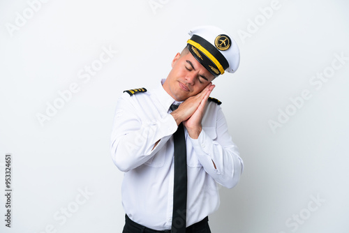 Airplane pilot caucasian man isolated on white background making sleep gesture in dorable expression photo