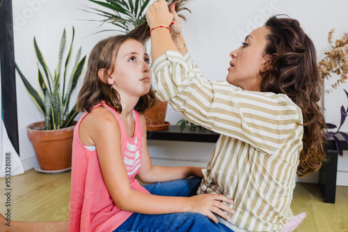 Bild auf Leinwand Head lices : mother examining nits to kid at home