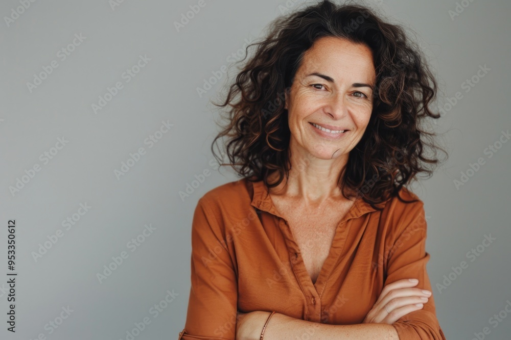 Portrait of a woman with curly hair wearing a brown shirt Portrait of a woman with curly hair wearing a brown shirt