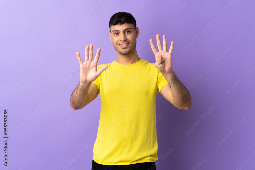 Young Colombian man isolated on purple background counting nine with fingers Young Colombian man isolated on purple background counting nine with fingers