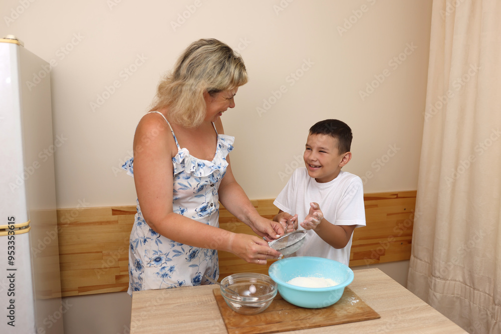 Mother and son prepare pizza dough. Cooking at home. Mother and son prepare pizza dough. Cooking at home.