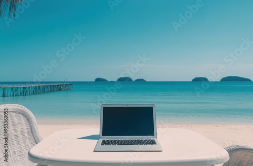 A laptop on the table in front of a blue sea and white sand beach with a pier, a vacation background for remote work or an online collage