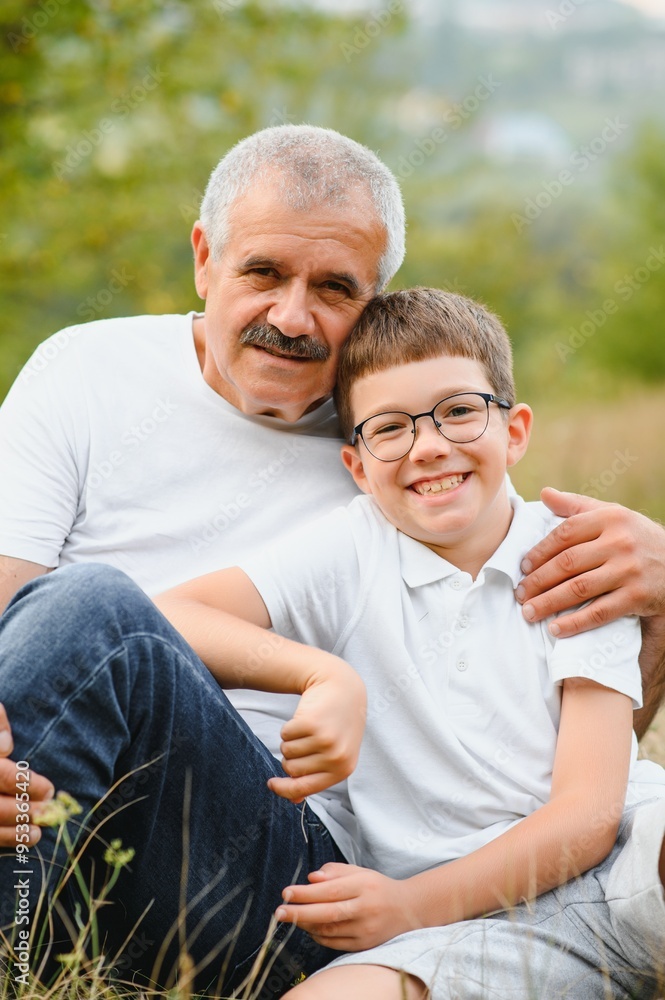 Happy grandfather embracing grandson in park Happy grandfather embracing grandson in park
