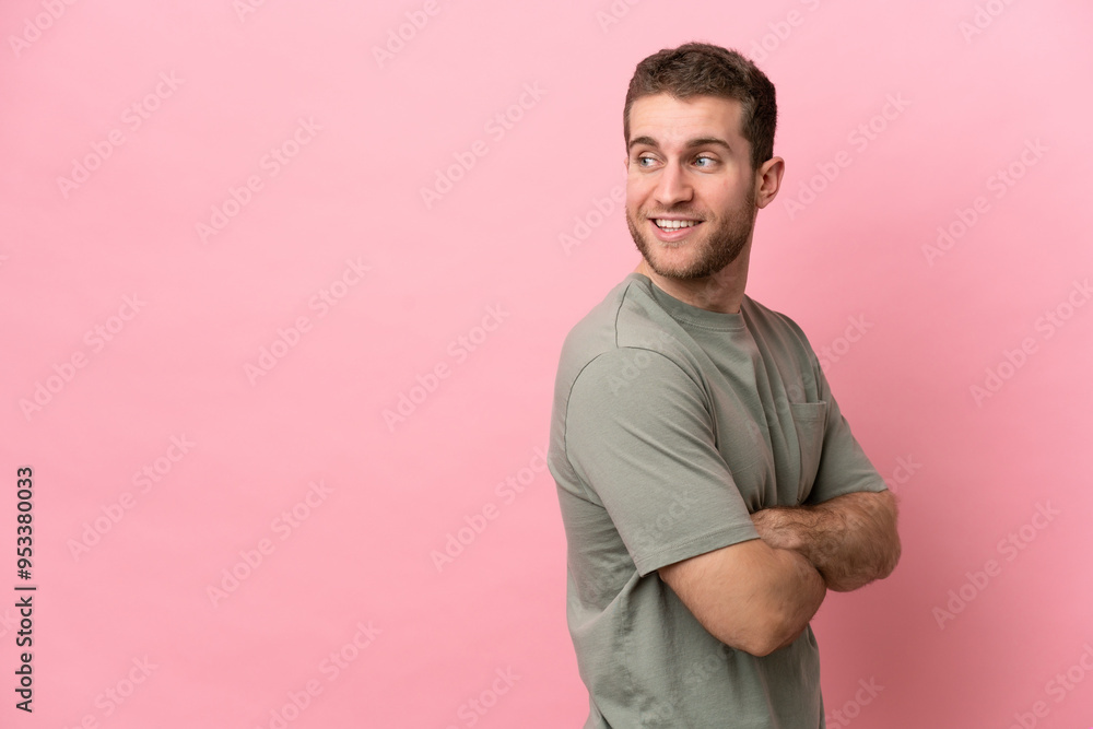 Young caucasian man isolated on pink background with arms crossed and happy Young caucasian man isolated on pink background with arms crossed and happy
