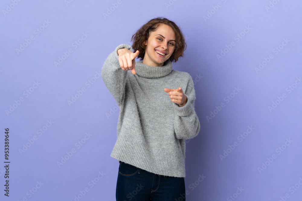 Young English woman isolated on purple background pointing front with happy expression Young English woman isolated on purple background pointing front with happy expression