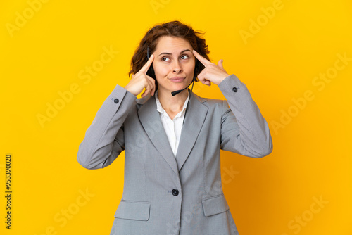 Young English woman isolated on yellow background having doubts and thinking photo